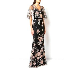 Marchesa Notte cape sleeve floral embroidered mermaid gown.